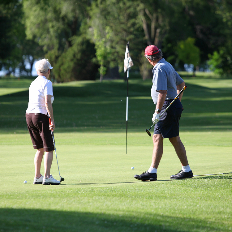 Older couple golfing