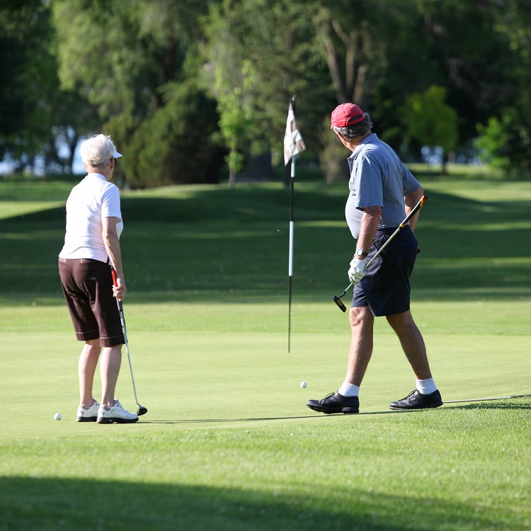 Older couple golfing